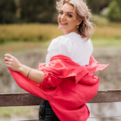 shantelle, wearing red jacket, white shirt, happy