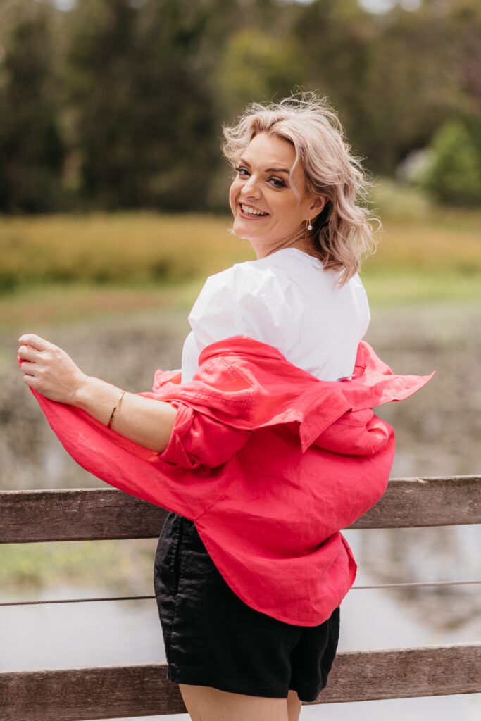 shantelle, wearing red jacket, white shirt, happy